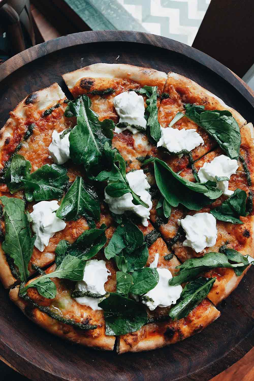 Artisanal wood-fired pizza with blistered crust and fresh mozzarella from The Green Man hearth